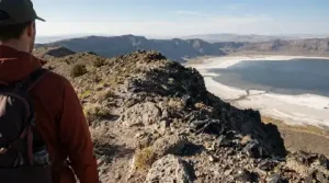 Hiker viewing volcanic crater lake